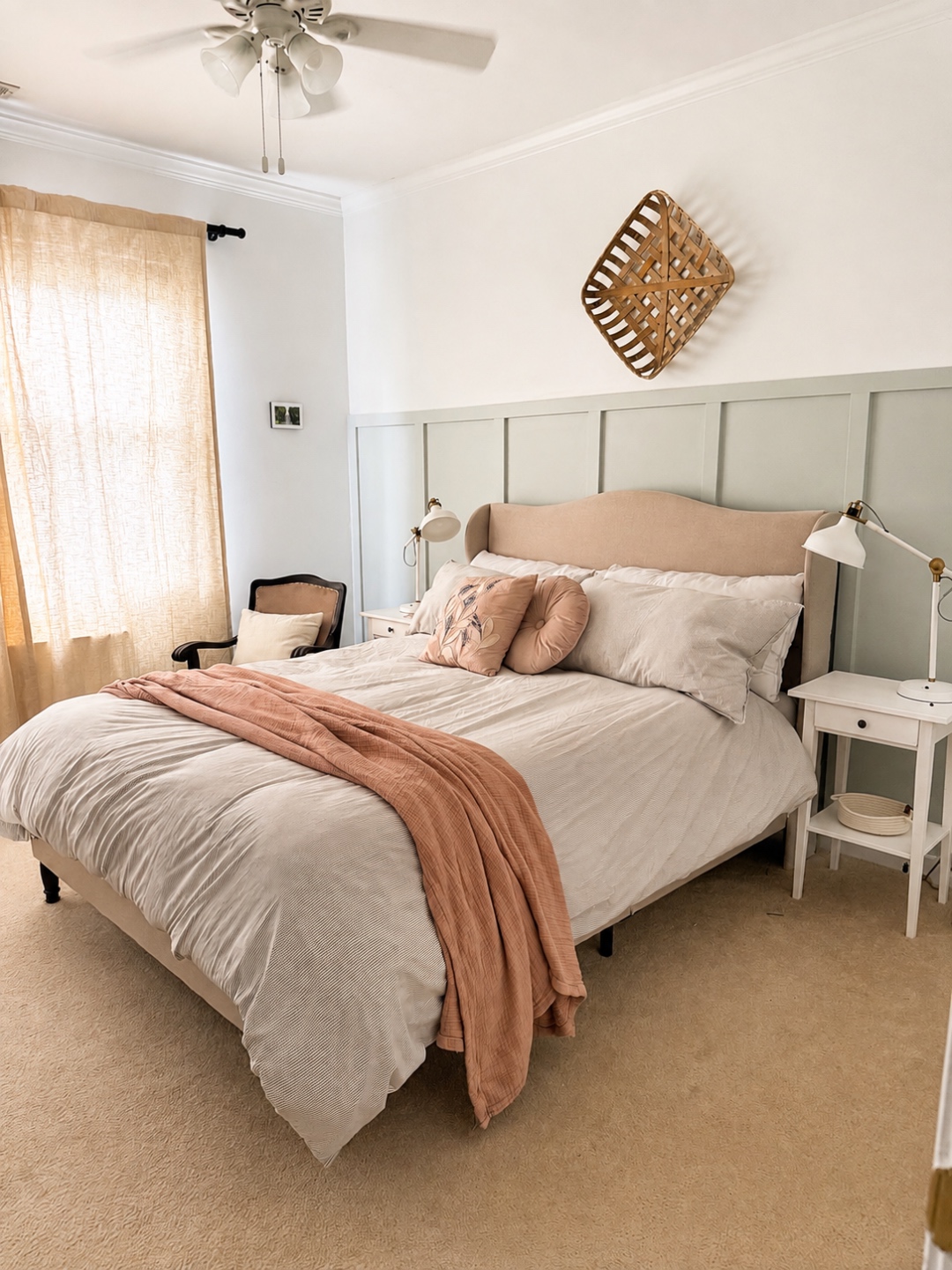 Guest bedroom with linen headboard and sage board-and-batten